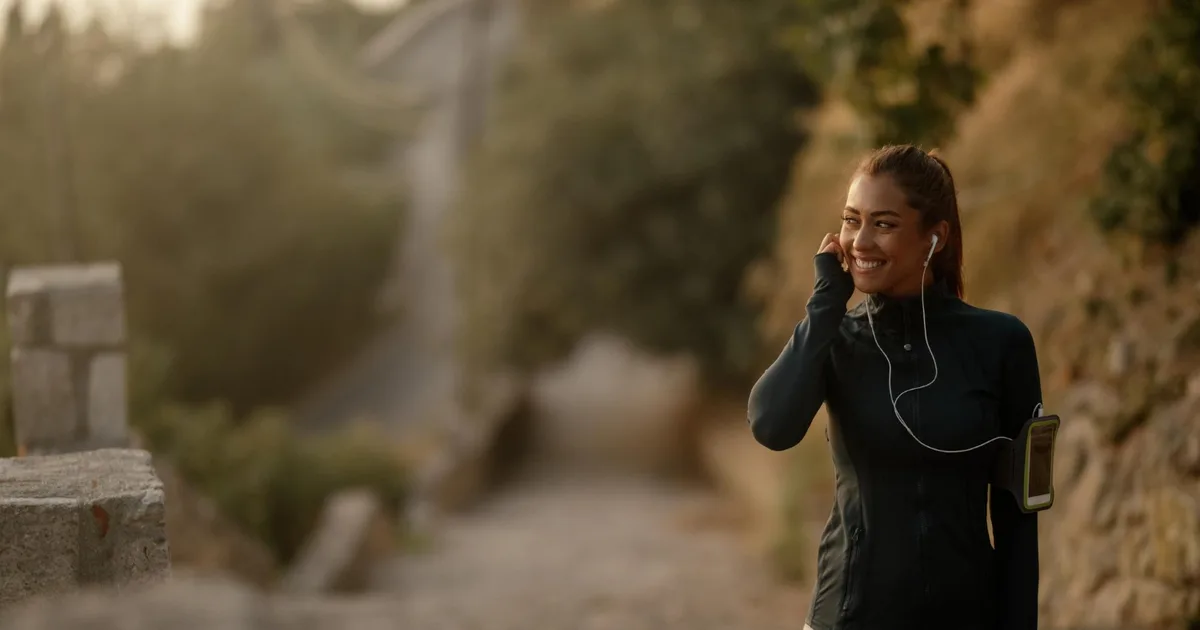 Beginner runner training at dawn in an urban park